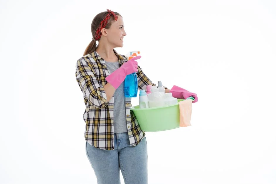 A couple wrapping furniture in a bright apartment, preparing to move.
